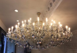 Large Theresian chandelier 63 light bulbs in a low interior