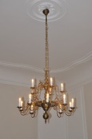 General view of a replica of a lit antique chandelier