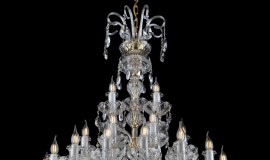The upper part of a luxury chandelier with crutches made of glass