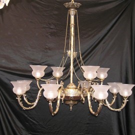 The large cast brass chandelier with sand-blasted vases