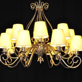 The custom-made silver tubular chandelier with the lampshades in cream color